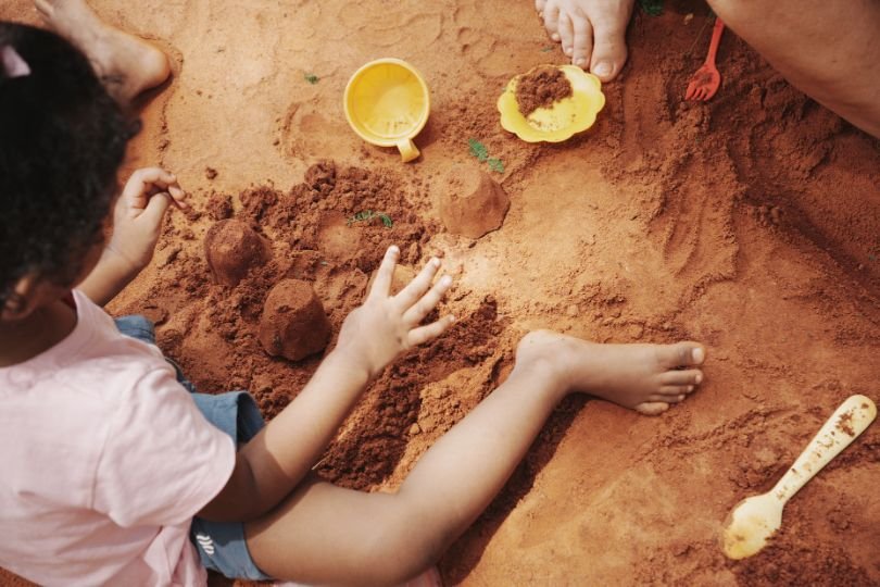 Little ones exploring and playing together in the sand